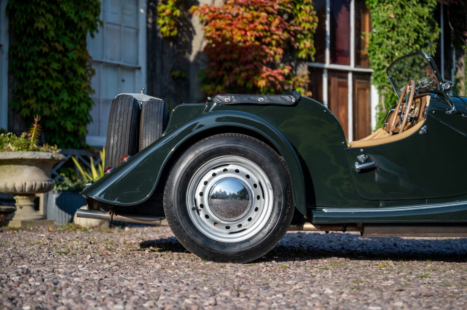 A close up of the side rear of a Morgan Car.